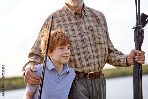 grandfather and grandson going to fish. Little helper fishing. Family Time Together. Happy family. senior male and little boy together fishing, in casualo clothes, teach and learn. hobby concept