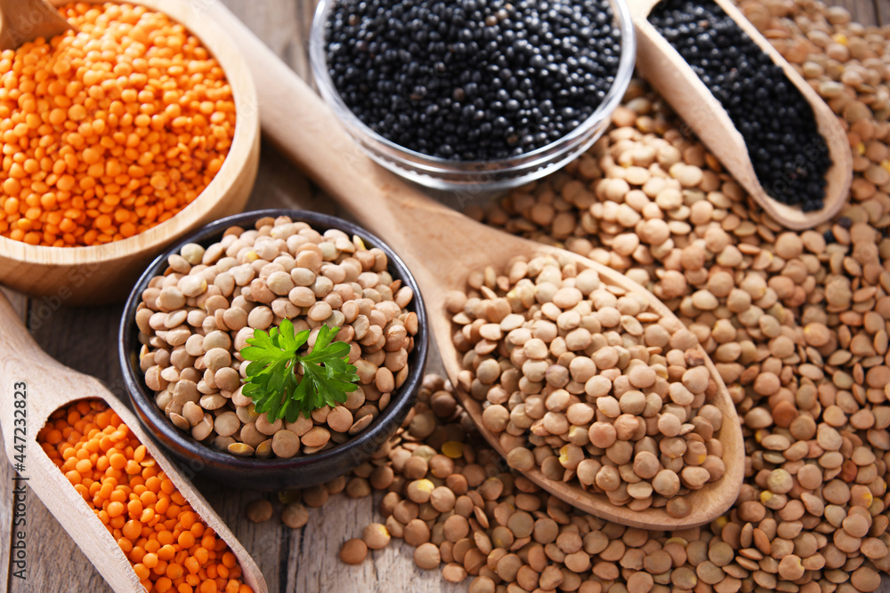 Composition with three sorts of lentils on wooden table Composition with three sorts of lentils on wooden table