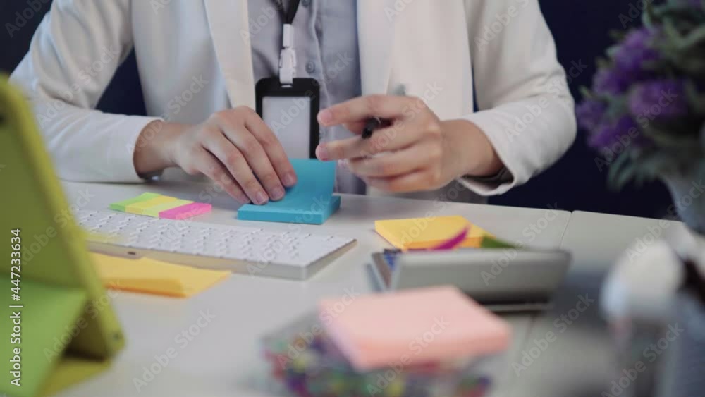 salary employee working at her desk in the office during office hours. salary employee working at her desk in the office during office hours.