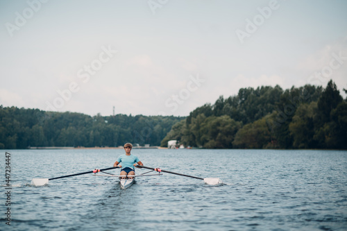 Obraz na plátně Sportsman single scull man rower rowing at competition boat regatta