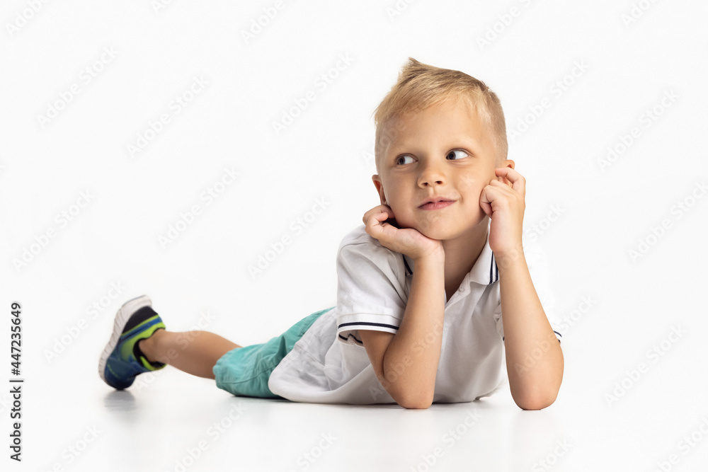 Portrait of cute preschool boy isolated on white studio background. Copyspace for ad. Childhood, education, emotion concept Portrait of cute preschool boy isolated on white studio background. Copyspace for ad. Childhood, education, emotion concept