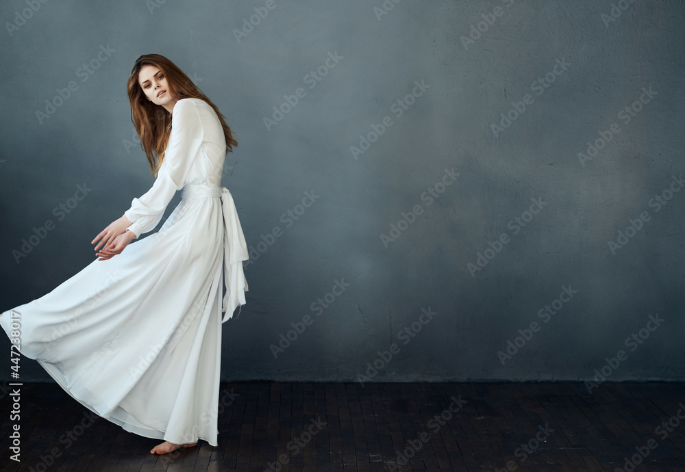 elegant woman in white dress dark background posing performance