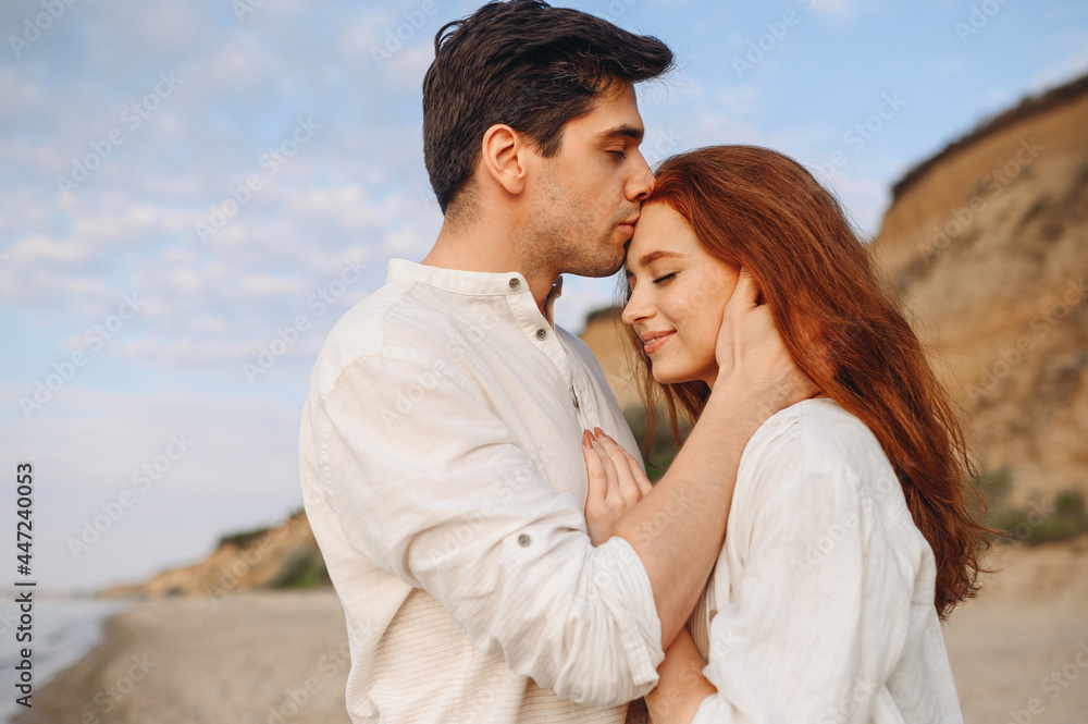 Side view close up smiling happy young lovely couple two friends family man woman in casual clothes hug each other kiss forehead at sunrise over sea beach outdoor seaside in summer day sunset evening Side view close up smiling happy young lovely couple two friends family man woman in casual clothes hug each other kiss forehead at sunrise over sea beach outdoor seaside in summer day sunset evening