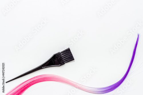 Brush and strand of coloring hair. Hair dye concept