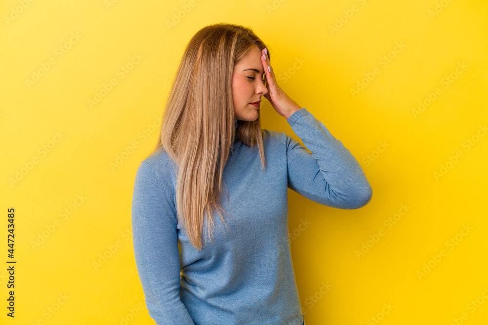 Young russian woman isolated on yellow background having a head ache, touching front of the face. Young russian woman isolated on yellow background having a head ache, touching front of the face.
