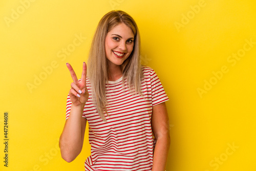 Young russian woman isolated on yellow background showing number two with fingers.