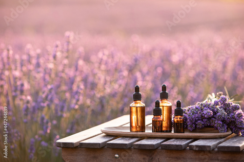 Ingredients of natural cosmetics from lavender. Composition from glass bottles of essential oil.