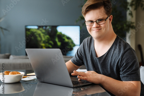 Smiling white young man with down syndrome photo