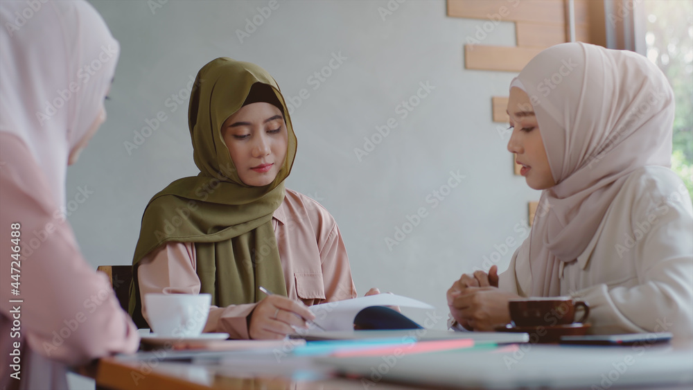 Upwardly mobile Asian Muslim business entrepreneur SME start up group of young man and women, discussing sale and marketing analysis, Asian Muslim SME teamwork e-commerce concept Upwardly mobile Asian Muslim business entrepreneur SME start up group of young man and women, discussing sale and marketing analysis, Asian Muslim SME teamwork e-commerce concept