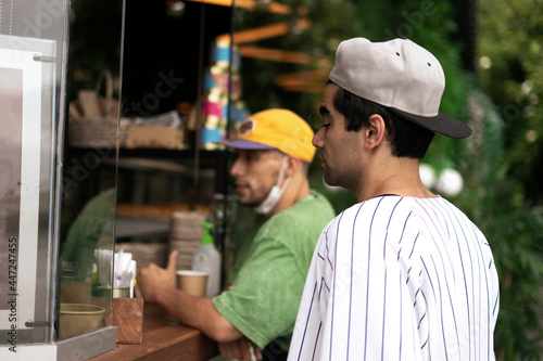 two guys buying food in the street cafe  lifestyle vacation