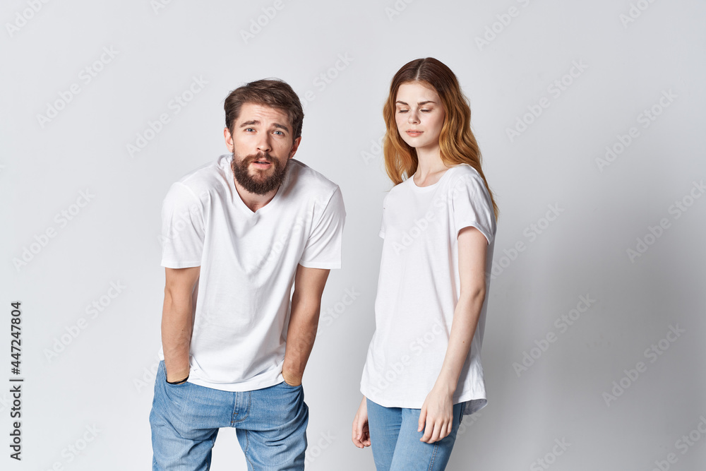 man and woman in white t-shirts posing fashion together communication man and woman in white t-shirts posing fashion together communication