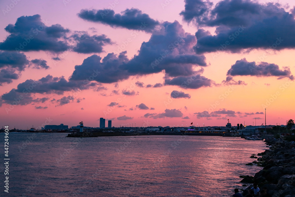hot pink sunset over the sea and the city
