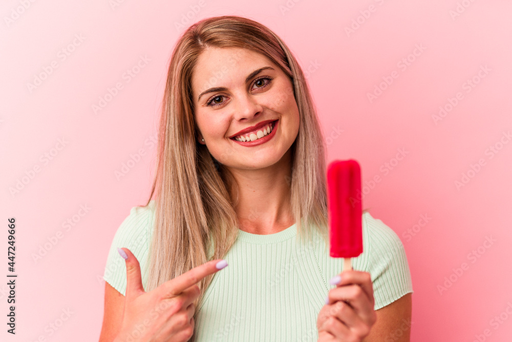 Young russian woman holding an ice cream isolated on pink background Young russian woman holding an ice cream isolated on pink background