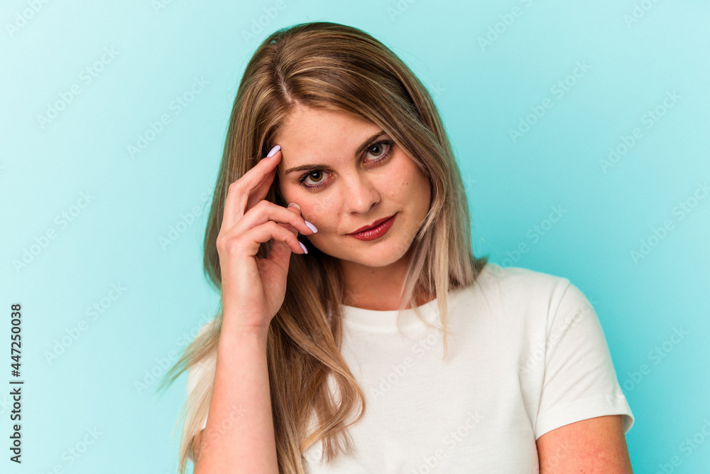 Young russian woman isolated on blue background Young russian woman isolated on blue background