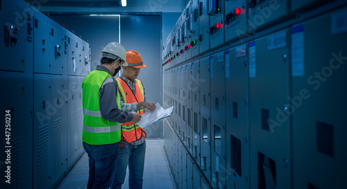 engineer checking and inspecting at MDB panel .he working with electric switchboard to check range of voltage working in Main Distribution Boards factory.	
