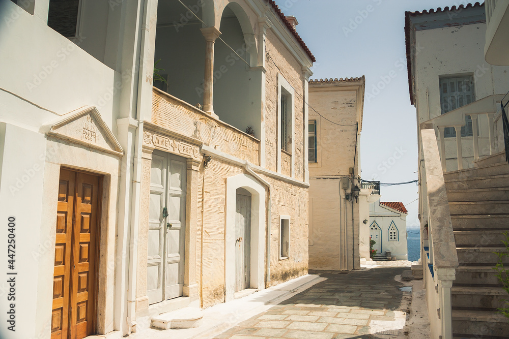 Beautiful street in city Chora on Andros island, Cyclades, Greece in summer sunny day