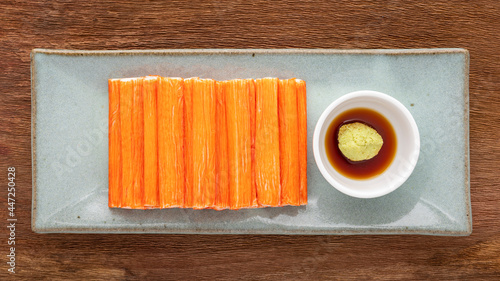 фотографія imitation crab sticks with wasabi and shoyu soy sauce in ceramic plate on rustic