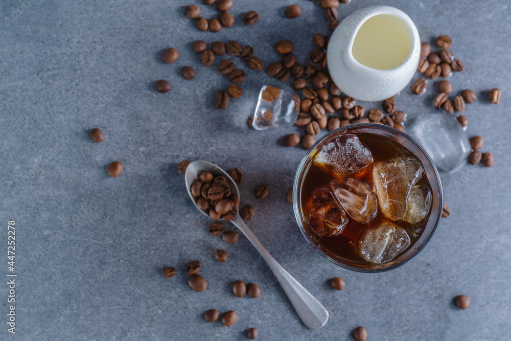 Fototapeta premium Iced coffee with ice cubes in glass