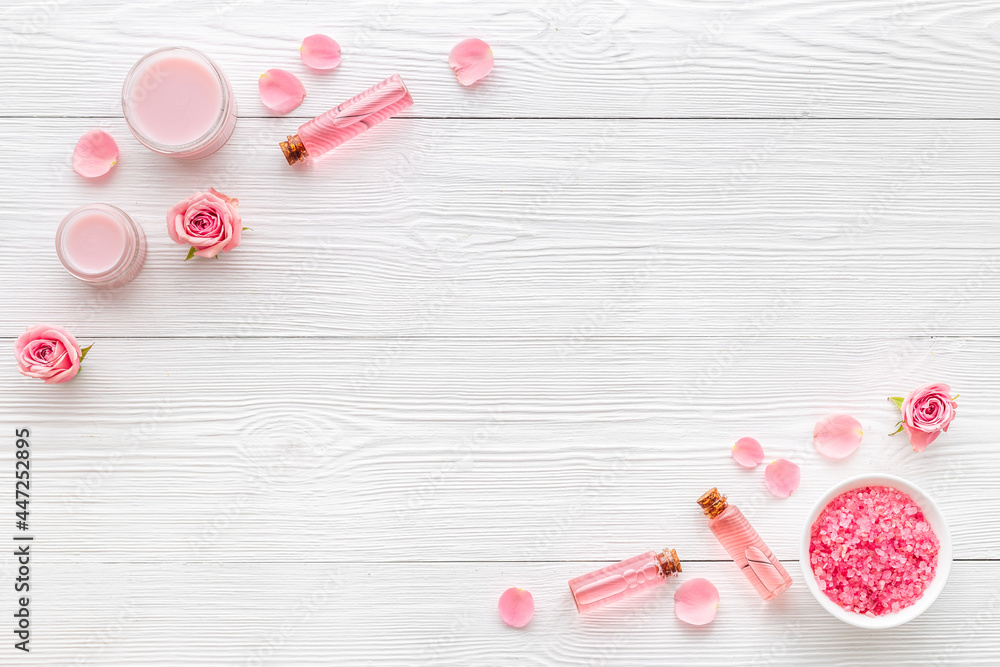 Flat lay of pink roses cosmetic with aroma oil and liquid for skin care Flat lay of pink roses cosmetic with aroma oil and liquid for skin care