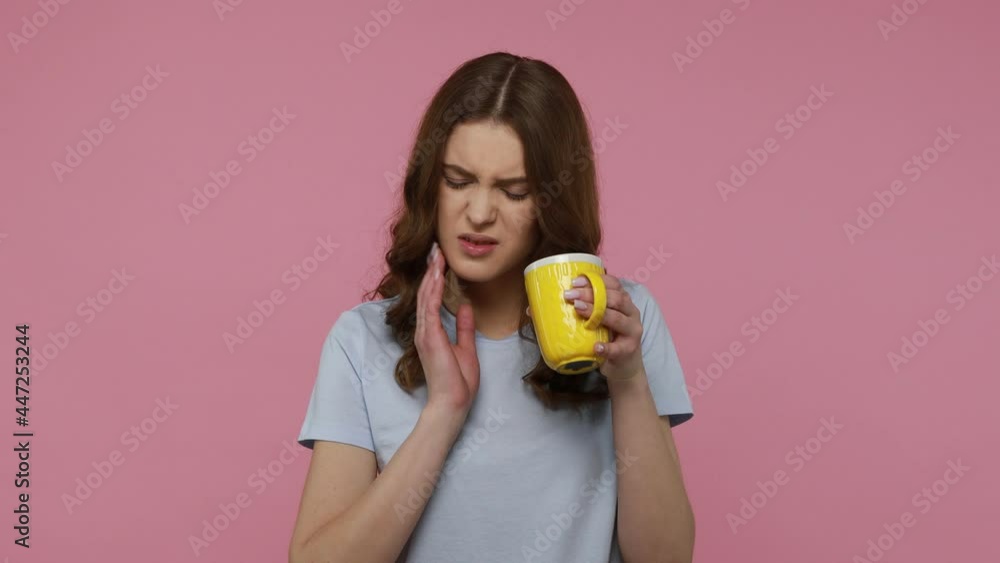 Sensitive teeth, damaged enamel. Attractive teenager girl drinking hot