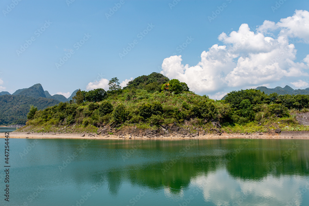beautiful lake with and green meadows and forests and small islands on the lake. Beautiful natural landscape with lake and mountains. beautiful lake with and green meadows and forests and small islands on the lake. Beautiful natural landscape with lake and mountains.