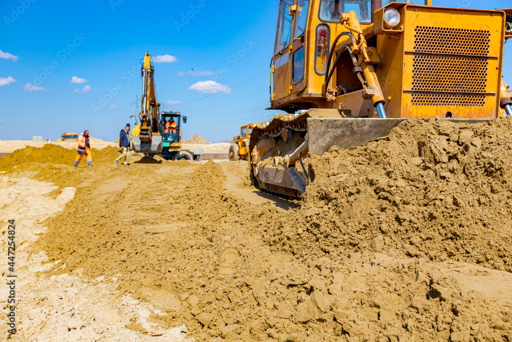 Obraz premium Bulldozer machine is leveling construction site.