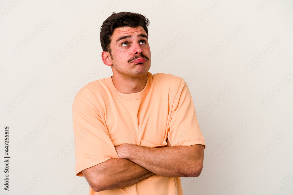 Fototapeta premium Young caucasian man isolated on white background tired of a repetitive task.