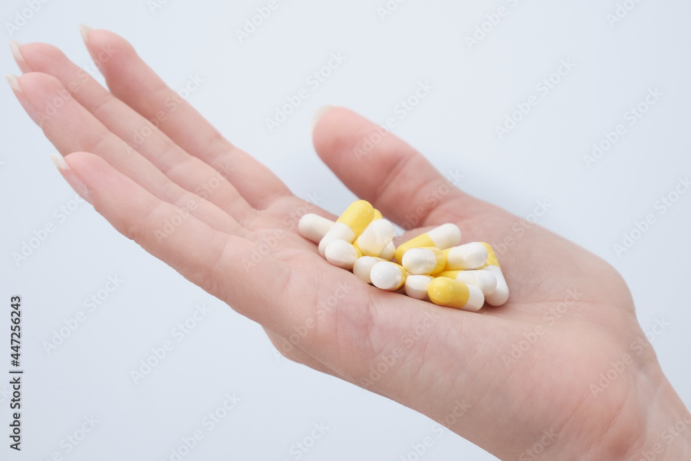 The capsules with the medicine are placed in the palm of the patient's hand The capsules with the medicine are placed in the palm of the patient's hand