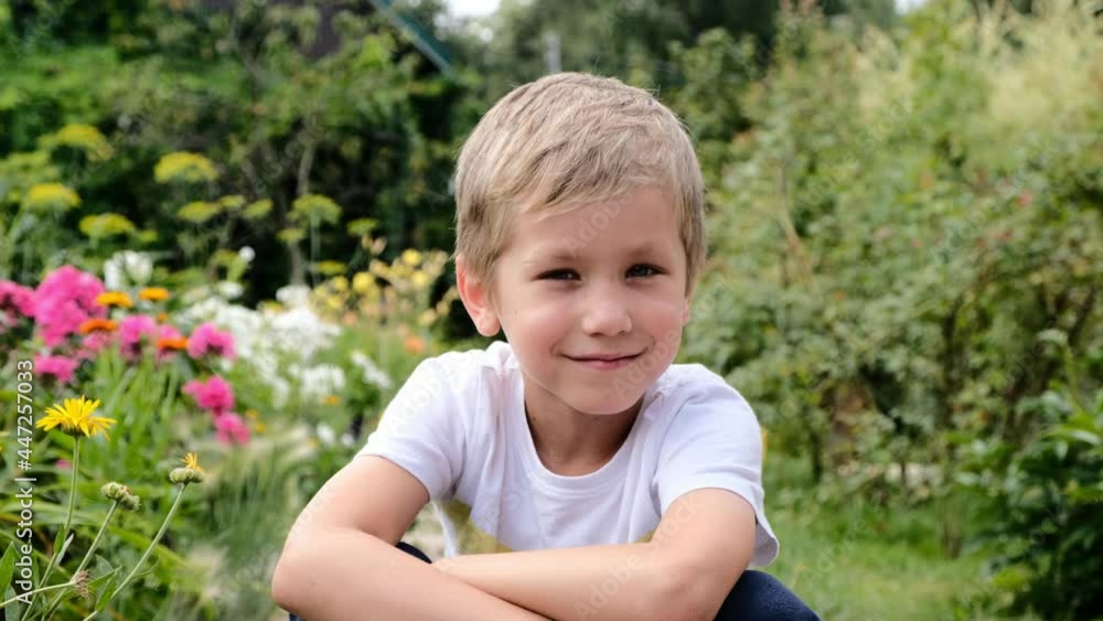 Happy cute boy 6 years old sitting outside and showing thumb up Happy cute boy 6 years old sitting outside and showing thumb up