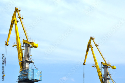 Cranes construction on the blue sky