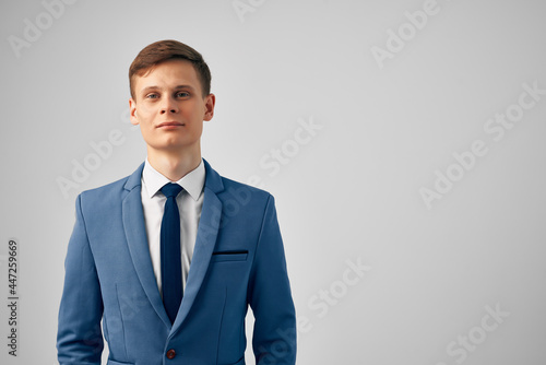 cheerful business man in suit gesturing with hand emotions posing studio