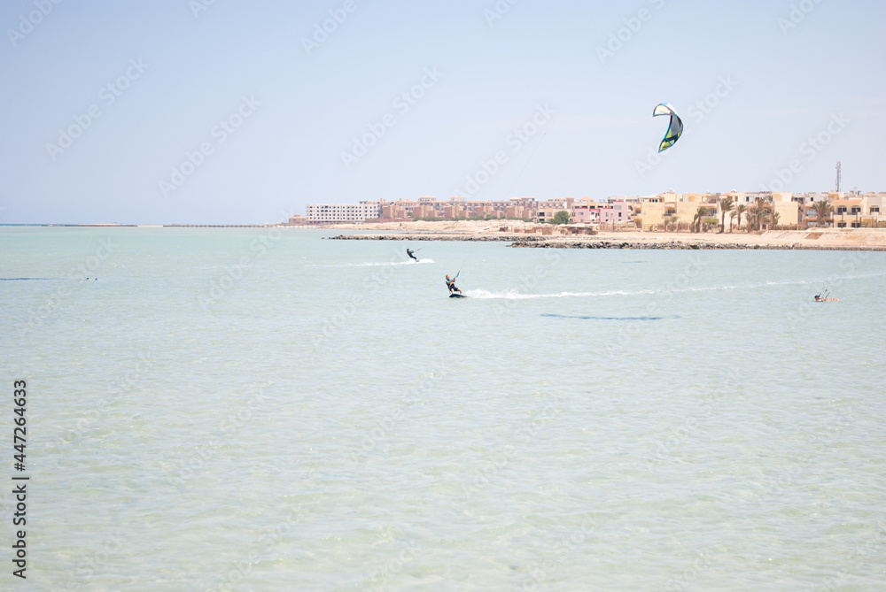 Kitesurfing on the shores of the sea against the backdrop of a stone African city