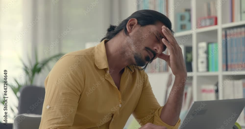 Man working with his laptop and having a headache Man working with his laptop and having a headache