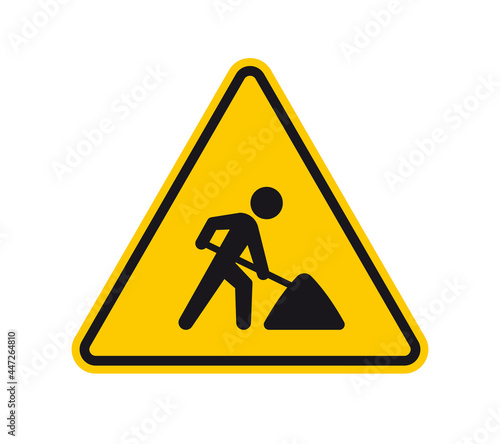 Vector yellow triangle sign - black silhouette figure with a shovel - roadwork. Isolated on white background.
