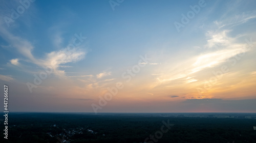 Colorful sky background sunset, illuminated pink-orange dramatic clouds, aerial photography, far horizon, setting sun. Ideal for sky replacement postproces. High quality photo