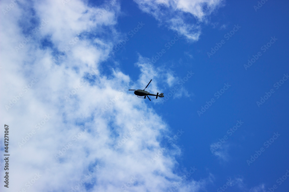 A fighter jet flying through a cloudy blue sky A fighter jet flying through a cloudy blue sky