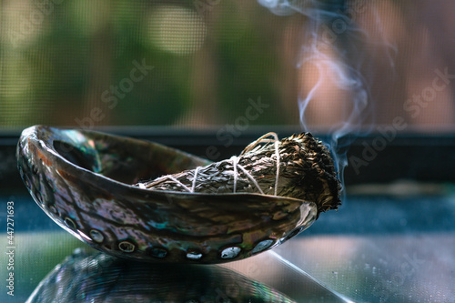 Bild auf Leinwand Burning sage up close in natural light with smoke in the frame