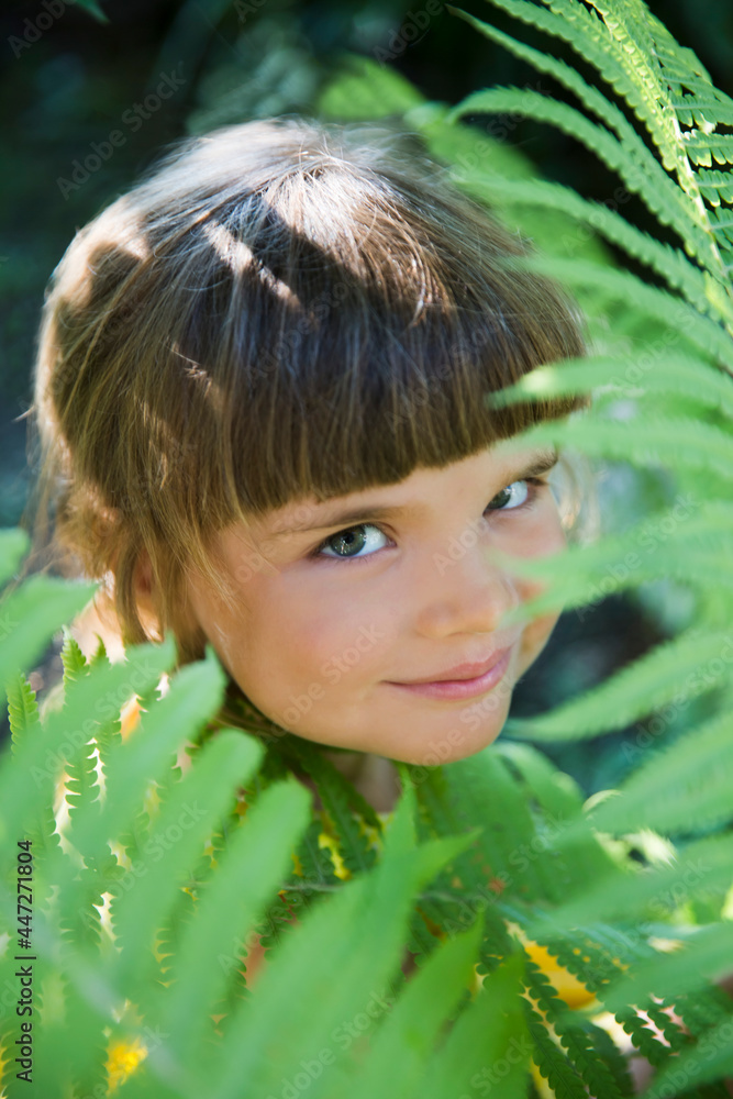 The child girl plays with fern leaf summer forest, joyful games in nature. Staycations, hyper-local travel, family outing
The child girl plays with fern leaf summer forest, joyful games in nature. Staycations, hyper-local travel, family outing