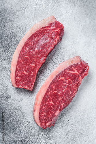 Raw cap rump or top sirloin beef meat steak. White background. Top view