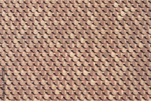 background of scalloped red clay roofing tiles