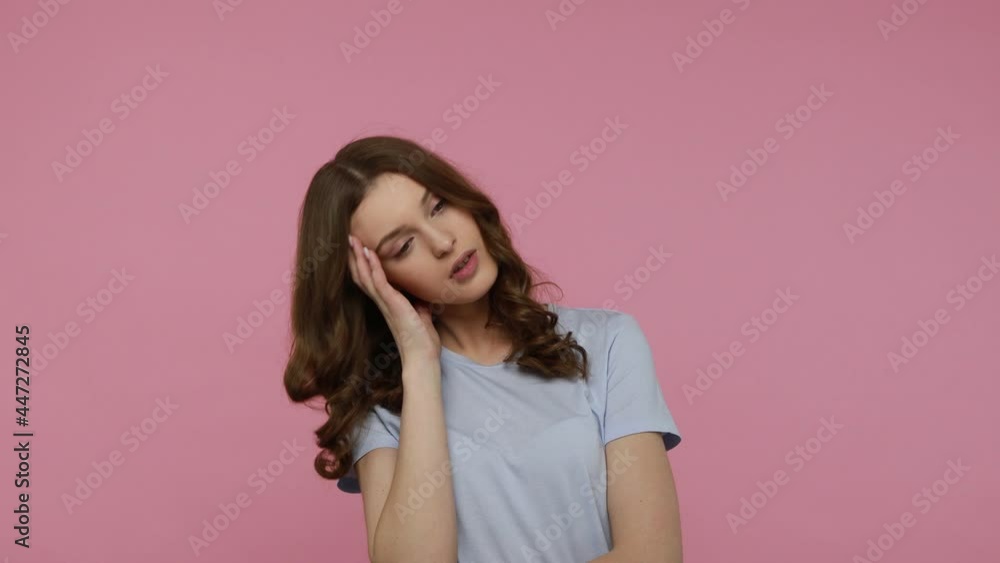 Unhappy sad teenager girl in casual clothing feeling sadness and depression, frustrated because of not interesting situation, being bored. Indoor studio shot isolated over pink background. Unhappy sad teenager girl in casual clothing feeling sadness and depression, frustrated because of not interesting situation, being bored. Indoor studio shot isolated over pink background.