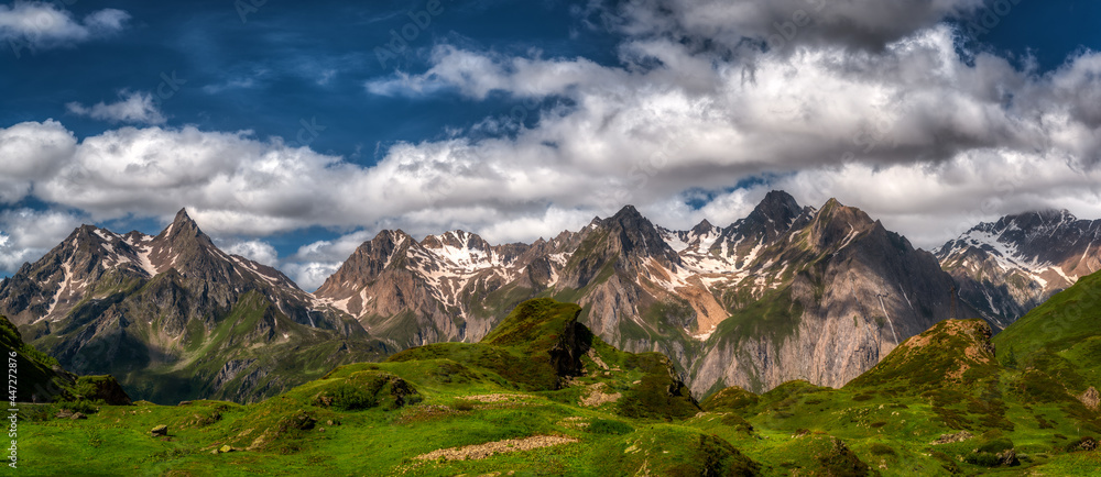 panorama of the mountains in summer season with clouds in the blue sky