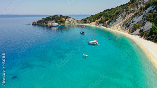 Aerial shot of moored luxury boats at the turquoise sea of Gidaki beach in Itaca, Greece photo