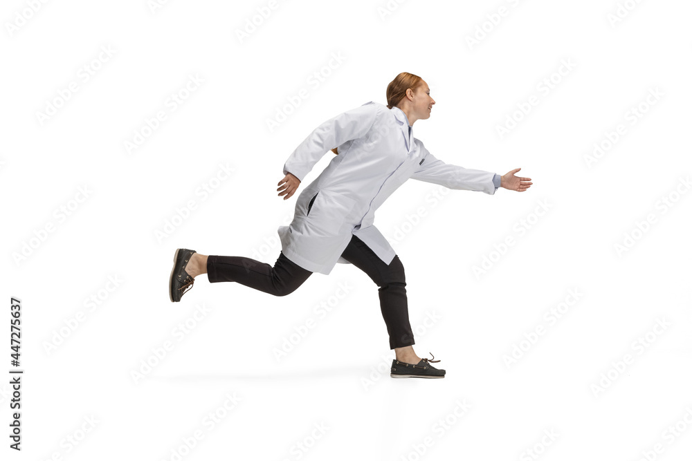 Portrait of running doctor, therapeutic or medical advisor in action and motion isolated on white background. Concept of healthcare, care, medicine and humor