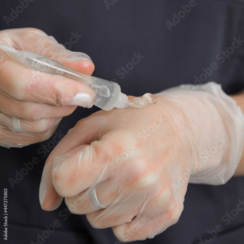 Beautician applies gel to a glove