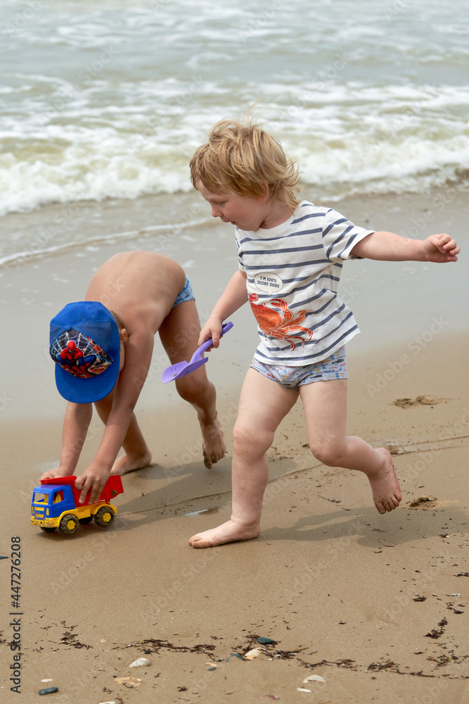 Two little boys are playing on the seashore Two little boys are playing on the seashore
