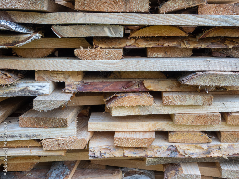 Firewood from boards stacked in a woodpile