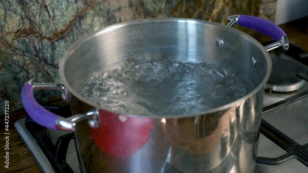Water Boils in a Pot on the Gas Stove of a Modern Kitchen, Closeup