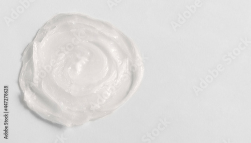 The texture of the lip balm. Transparent ointment on a white background and copy space photo