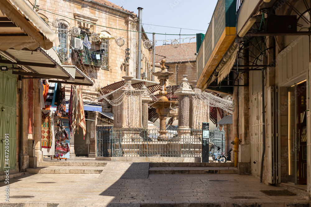 Empty street Al Souq with shops and restaurants closed due to coronavirus and fountain Muristan in the Christian quarter of Muristan in the old city of Jerusalem, Israel